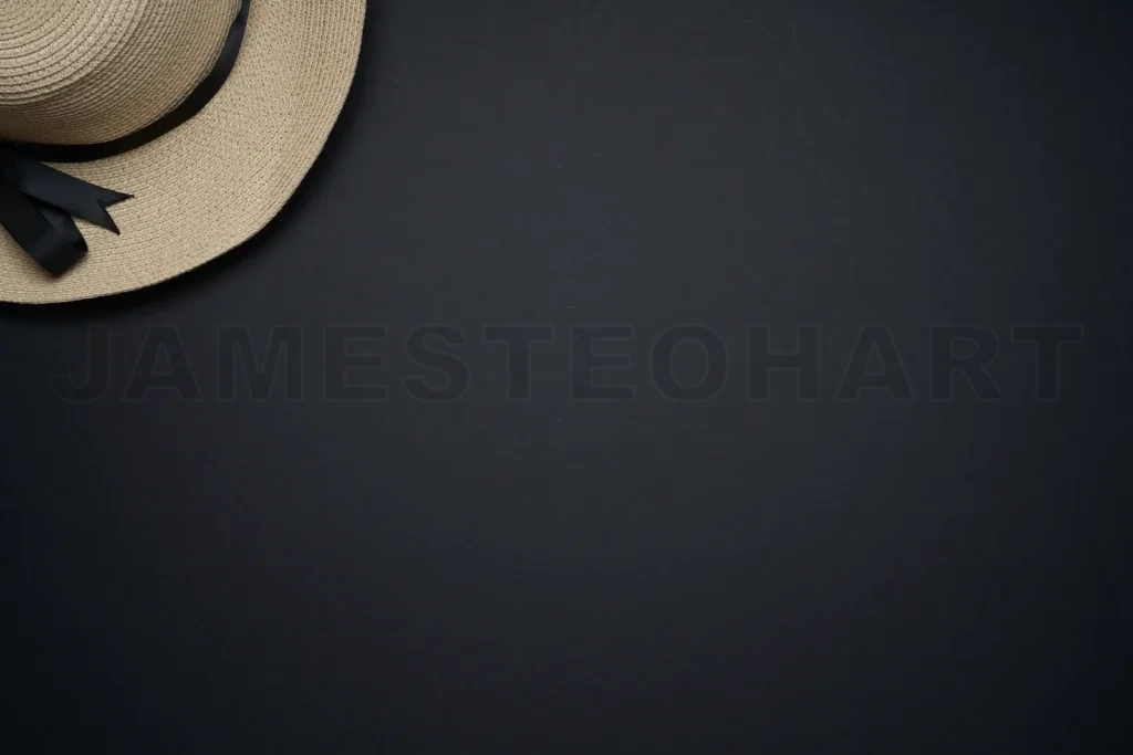 
Straw hat with black ribbon on dark background