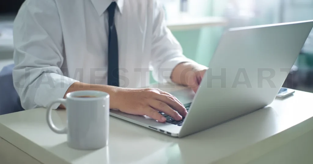 
Professional working on laptop in modern office environment