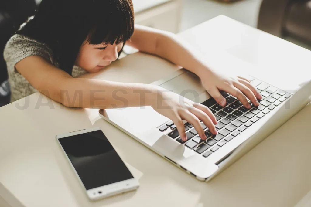
Cute Asian Little Girl Using Laptop At Home