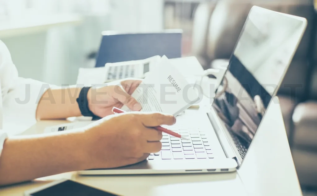 
Business Man Review His Resume On His Desk, Laptop Computer, Calculator And Cup Of Coffee,Seleted Focus
