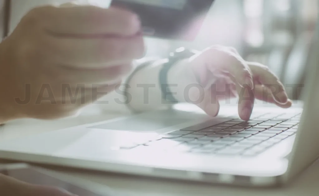 
Young Man Holding Credit Card And Using Laptop Computer