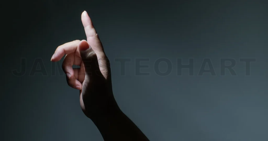 
Male Hand With Finger Pointing On Dark Background