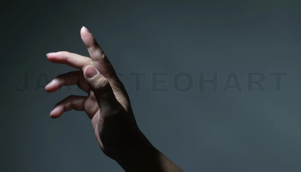 
Male Hand With Finger Pointing On Dark Background