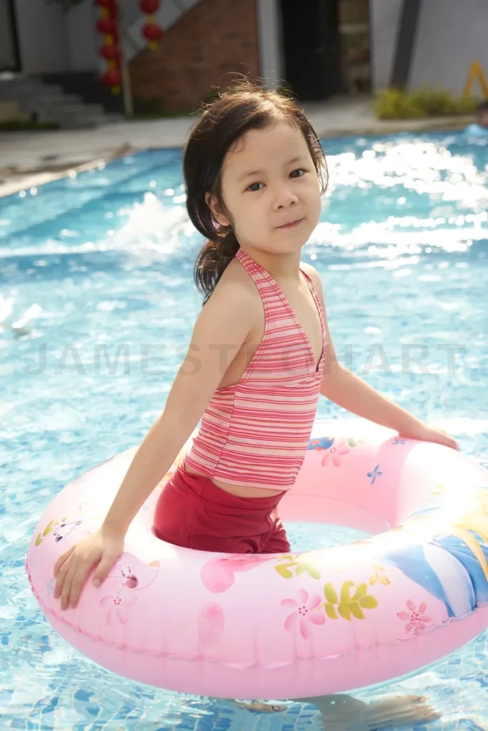 
Young girl enjoying summer pool time