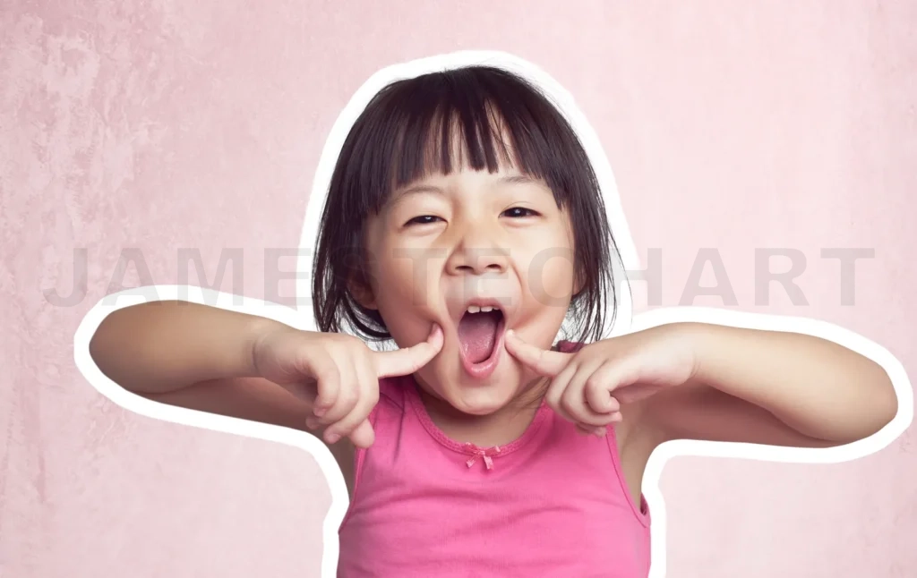 
Little girl making funny face on pink background