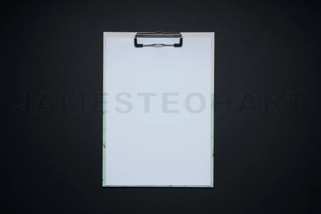 
Blank clipboard with white paper on dark background