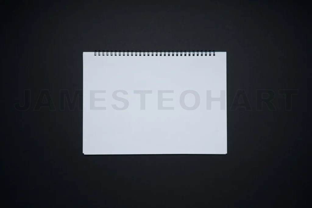 
Spiral bound blank white notepad on black background