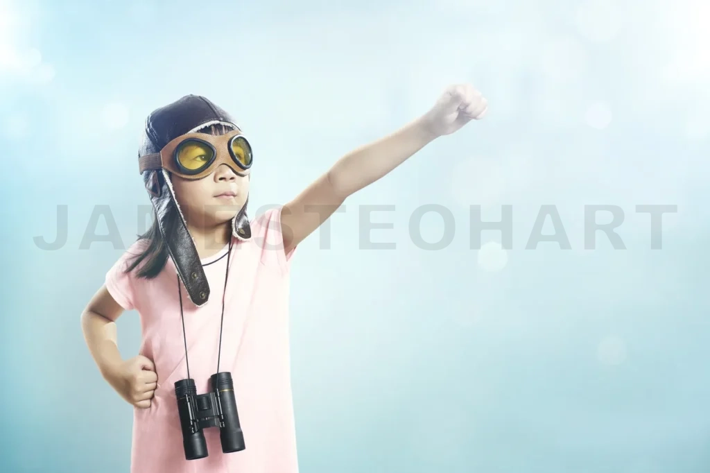 
Little Asian Girl Wear Aviator Glasses And Telescope; Dreams Of Becoming A Pilot Or Explorer; Flare And Bokeh Effect Apply With Vintage Mint Green Wall Background