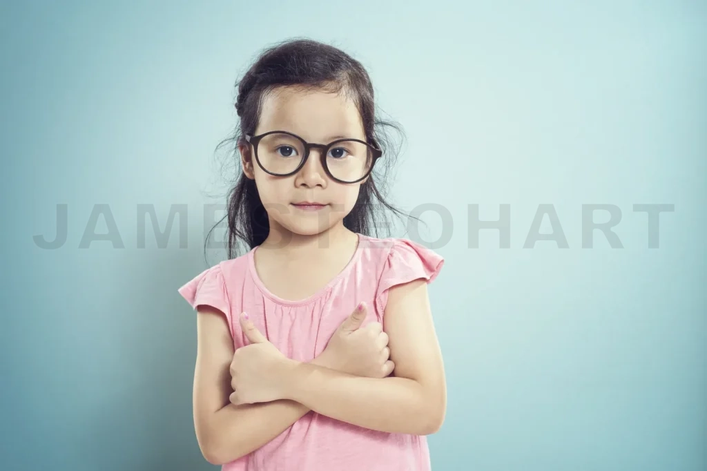 
Portrait Of Young Asian Little Cute Girl Shows A Thumbs Up By Two Finger Pose