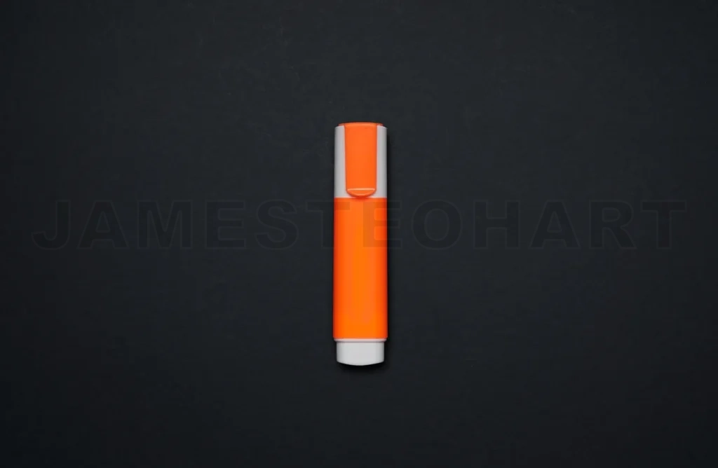 
Orange highlighter stationery tool on black background