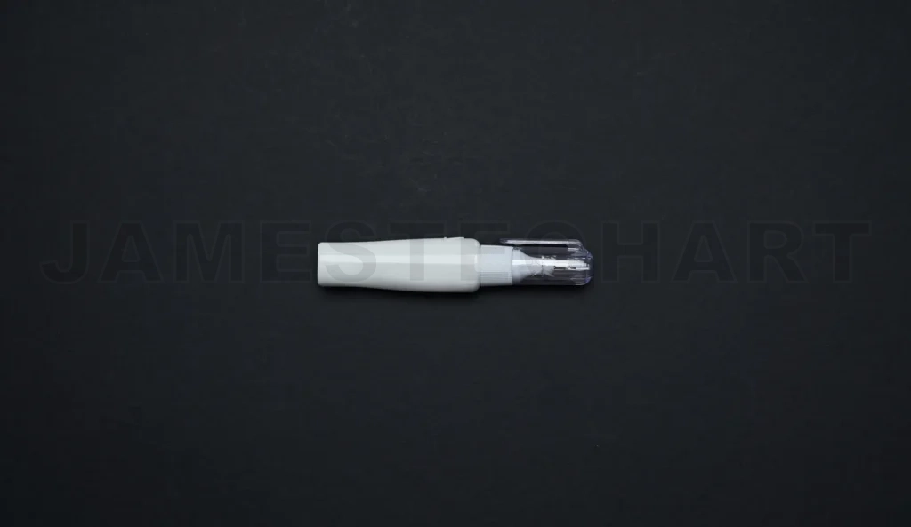 
White correction pen lying on black background