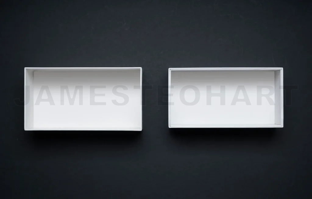 
Two white cardboard boxes on black background