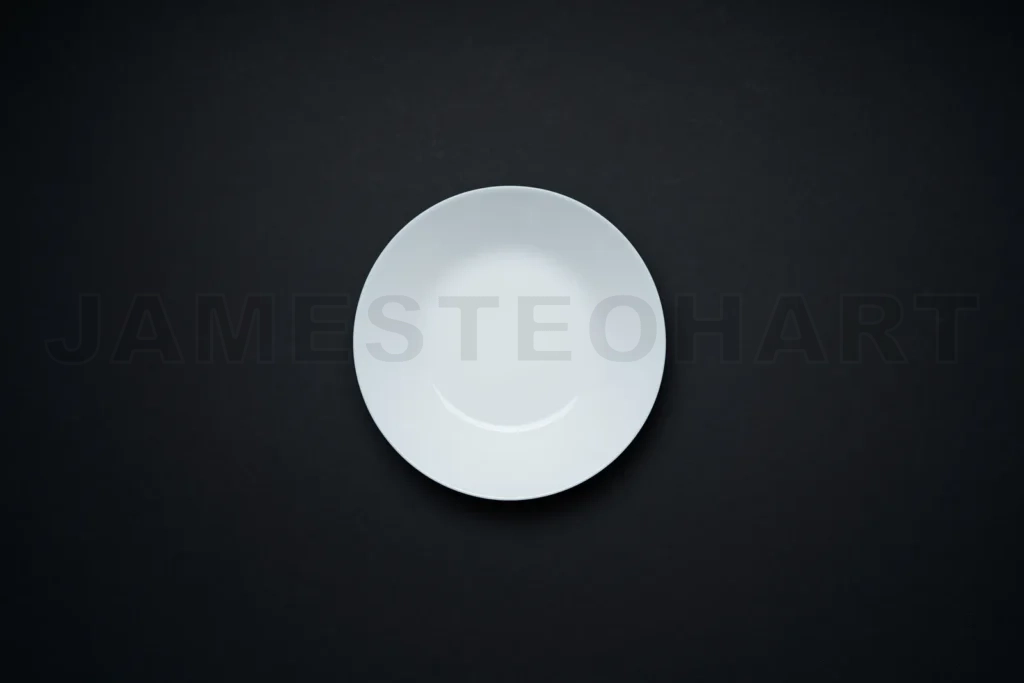 
Empty white plate centered on black background