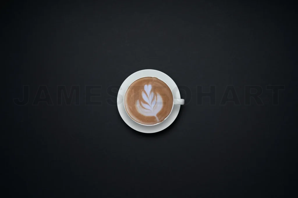 
Coffee cup with latte art on dark background