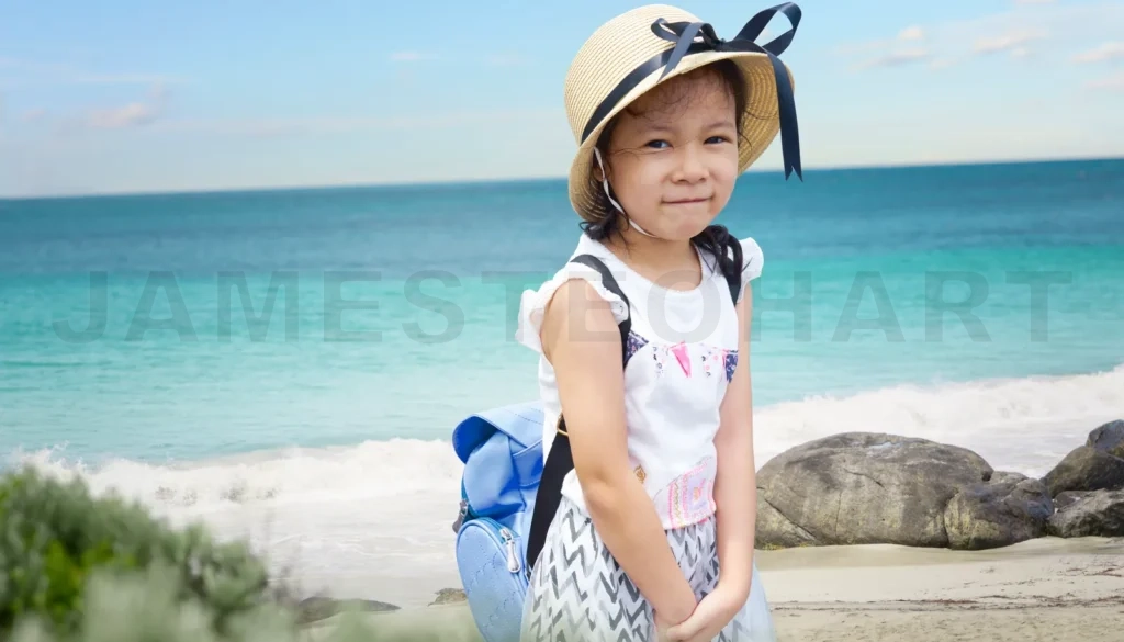 
Young girl wearing sun hat enjoying beach vacation