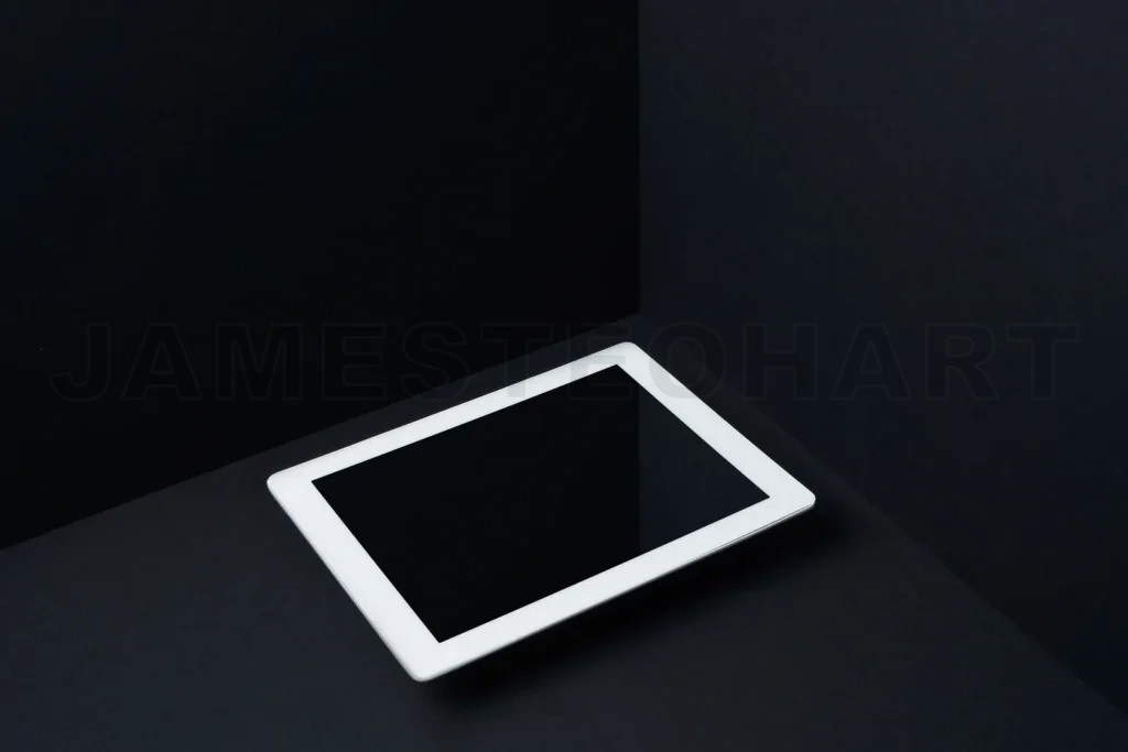 
White tablet blank screen on black background