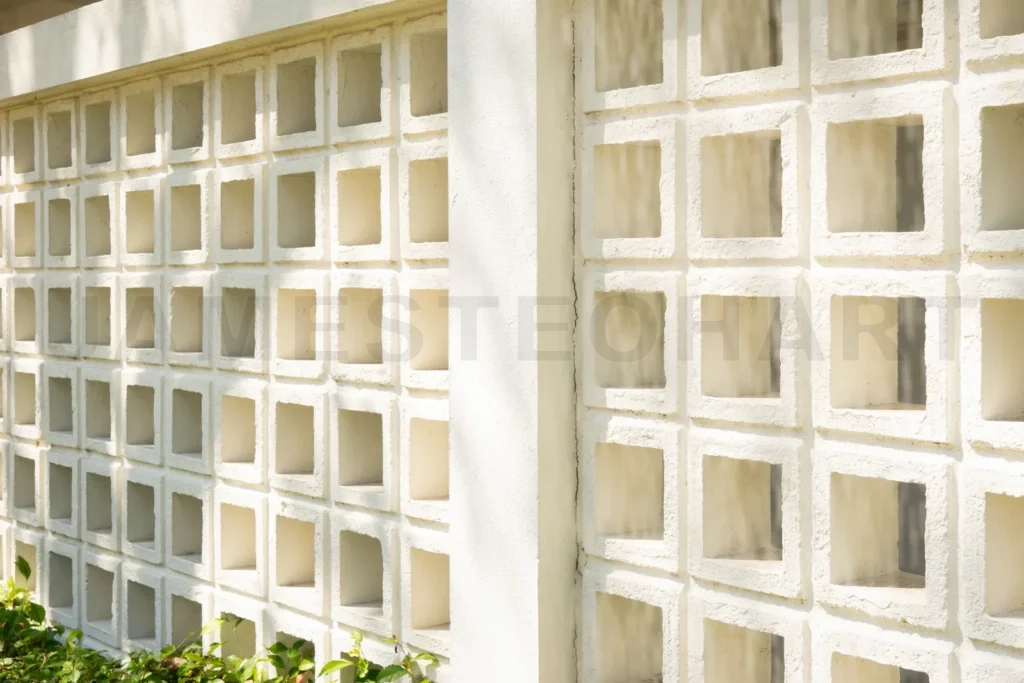 
White concrete breeze block wall creating geometric pattern