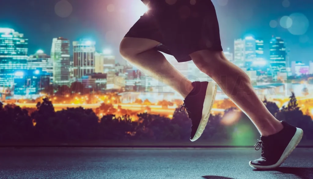 
Close Up Of Urban Runner Legs Run On The Night Street