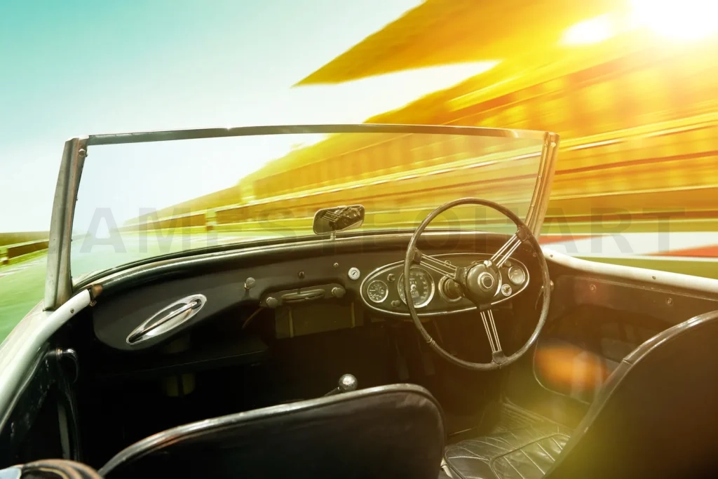 
Vintage sports car driving fast on a sunny track