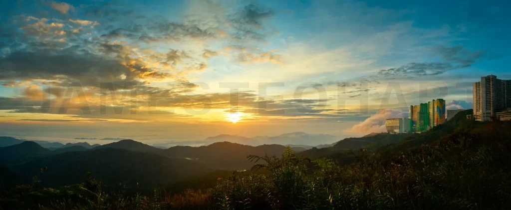 
Sunrise illuminating lush valley and buildings in genting highlands, malaysia