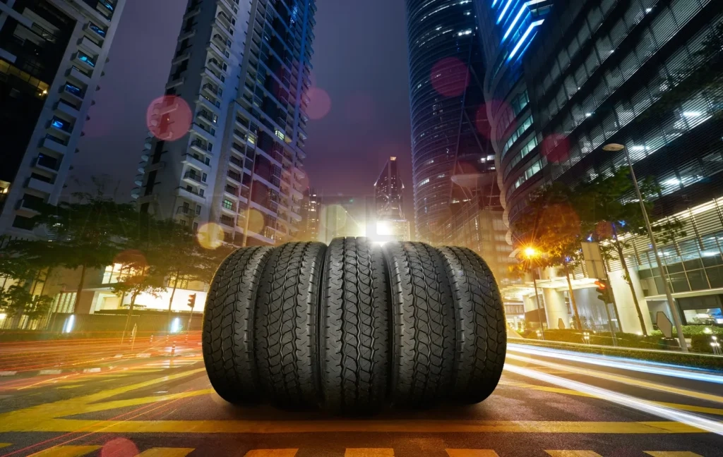 
Car Tires Pile On A Night City Street Road
