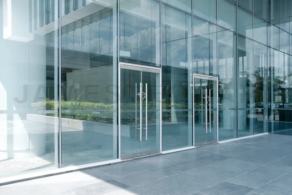 
Modern glass building exterior with reflecting facades and entrance