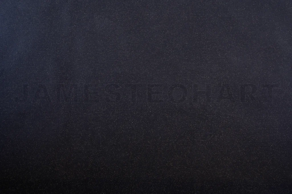 
Dark speckled texture background with glitter effect