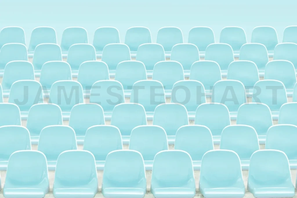 
Empty stadium seats creating a symmetrical light blue pattern