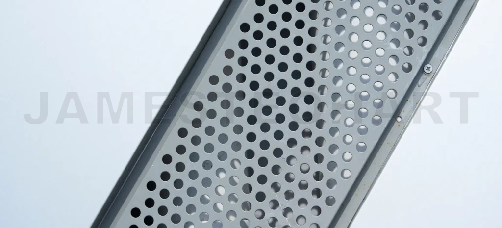 
Gray perforated metallic sheet creating abstract pattern
