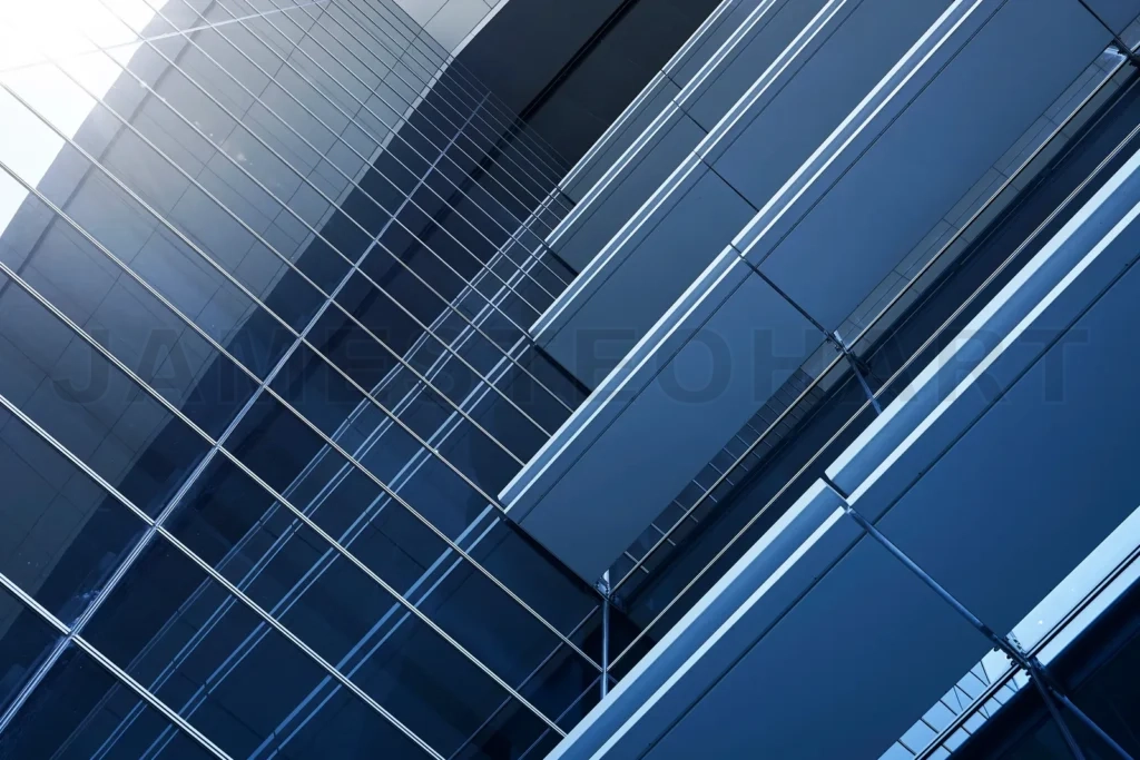 
Modern building facade featuring geometric glass and steel patterns