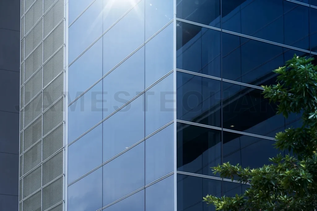 
Modern office building glass facade reflecting sunlight