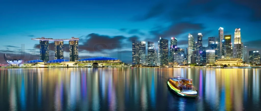 
Singapore city skyline reflecting on marina bay water at night