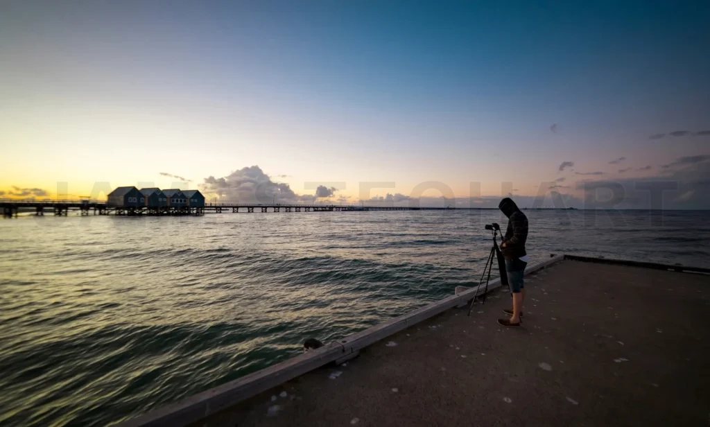 
Photographer recording sunset over busselton jetty pier