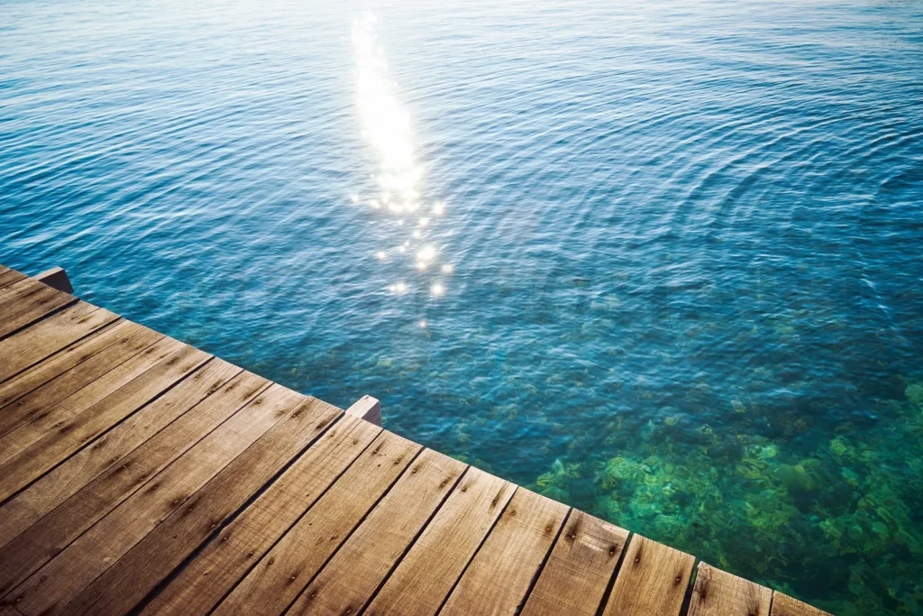 
Wooden dock extending over clear blue water