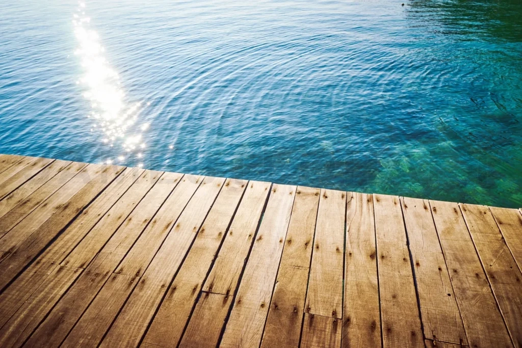 
Wooden deck overlooking clear blue sea water