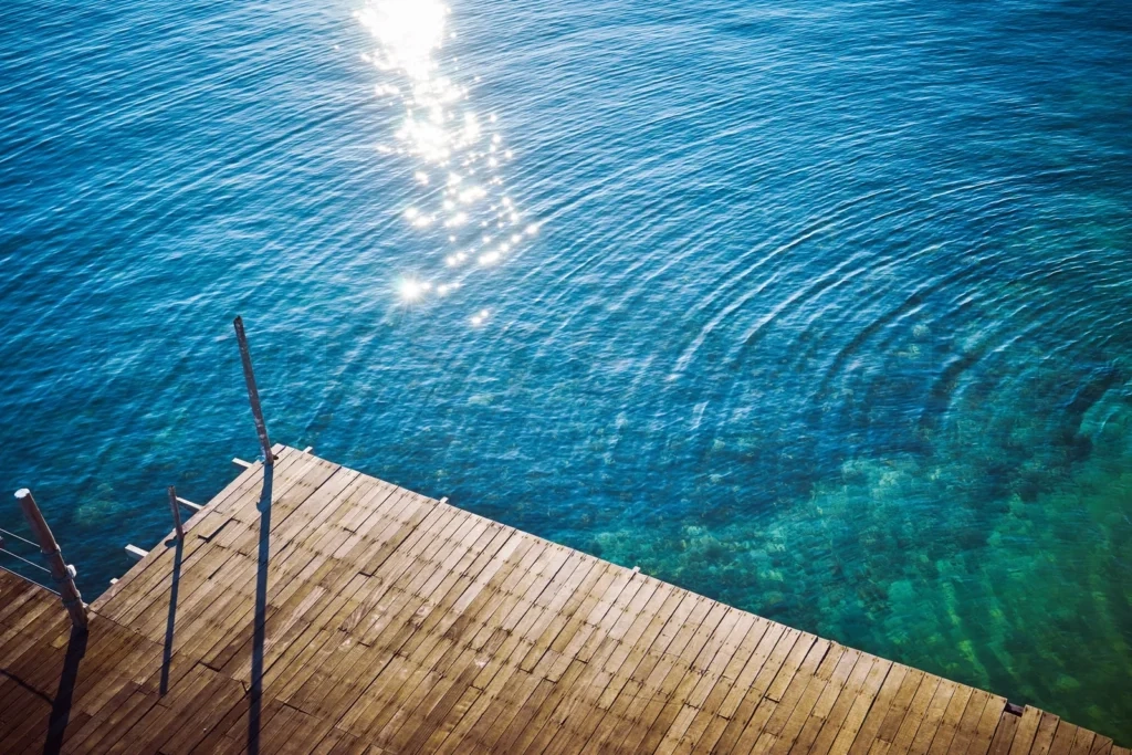 
Wooden pier extending into serene blue water