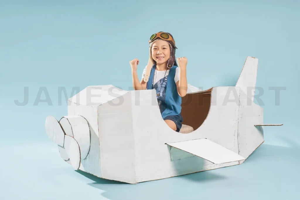 
Child pilot triumphing in cardboard airplane, dreaming of flight