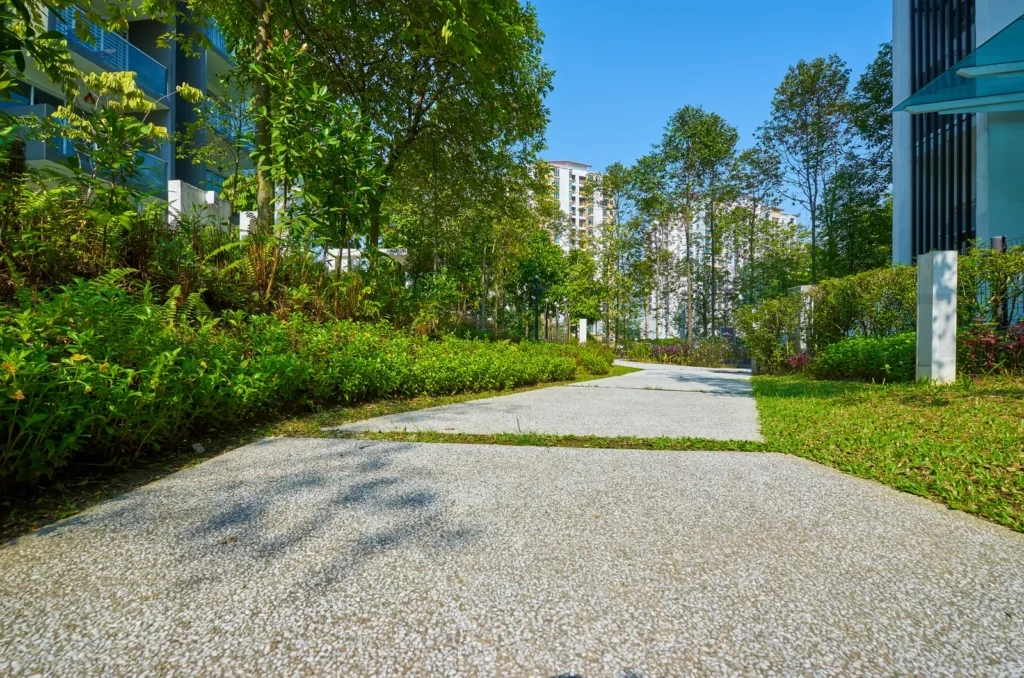 
Green urban pathway winding through residential garden landscape