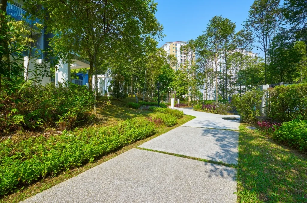 
Lush urban garden path leading to residential buildings