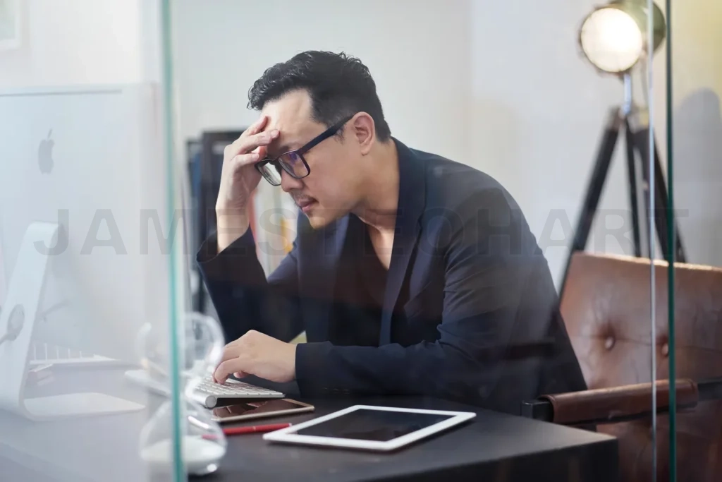 
Frustrated businessman suffering from headache and stress at work