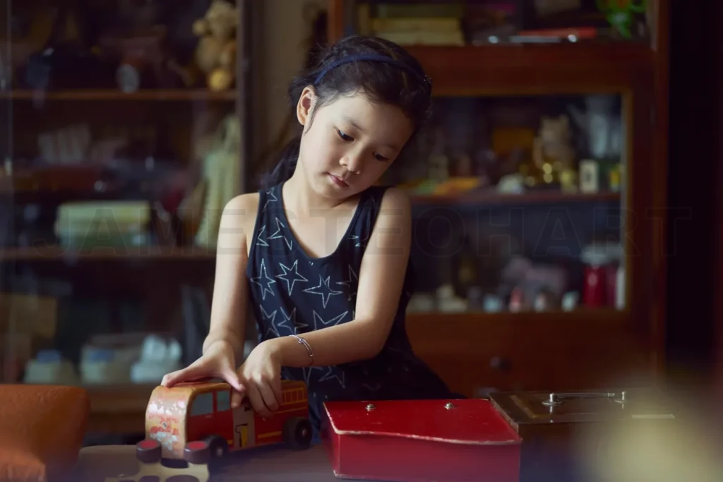 
Young girl playing with vintage toy truck