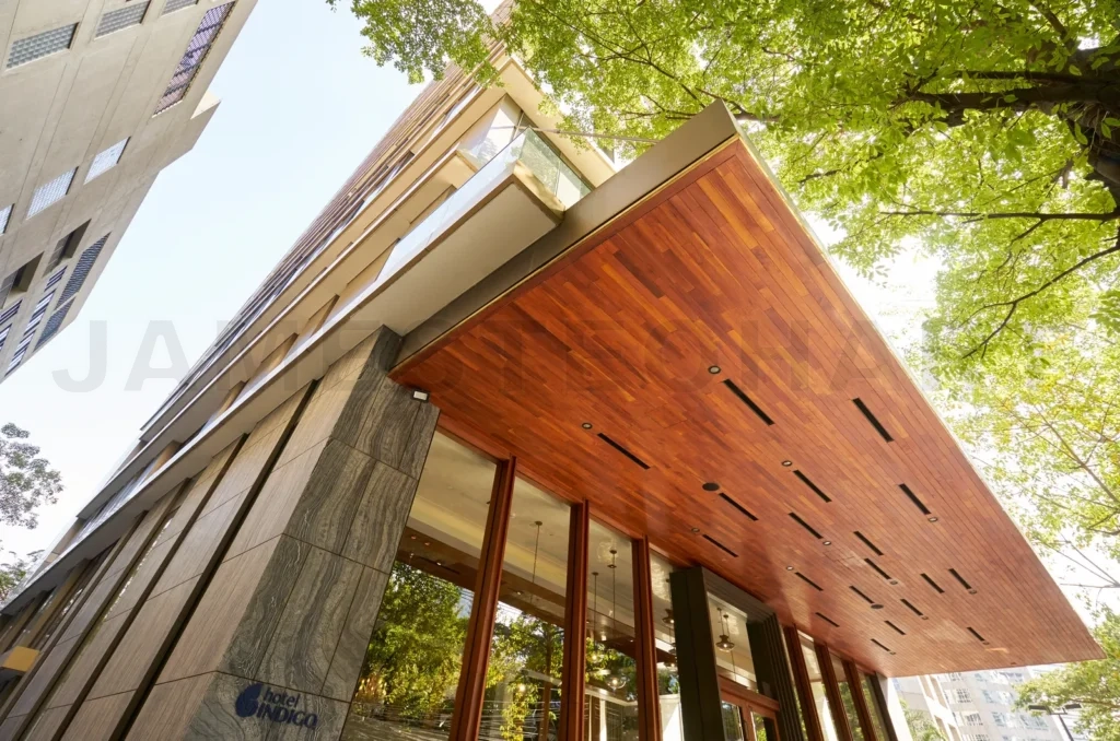 
Modern high-rise building entrance with wooden overhang