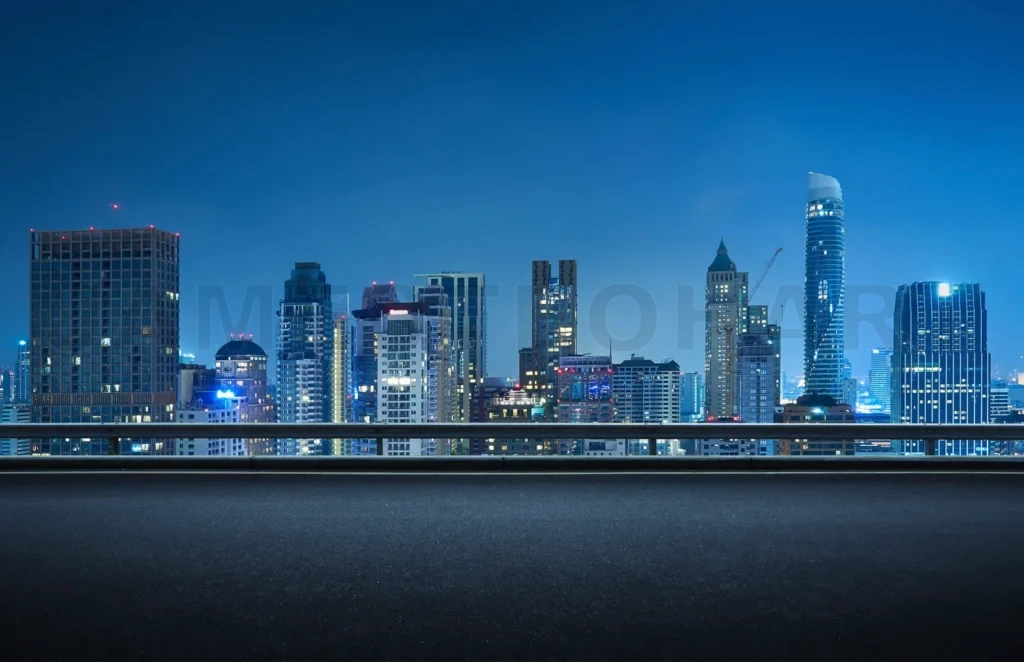 
Empty rooftop road overlooking city skyline at night