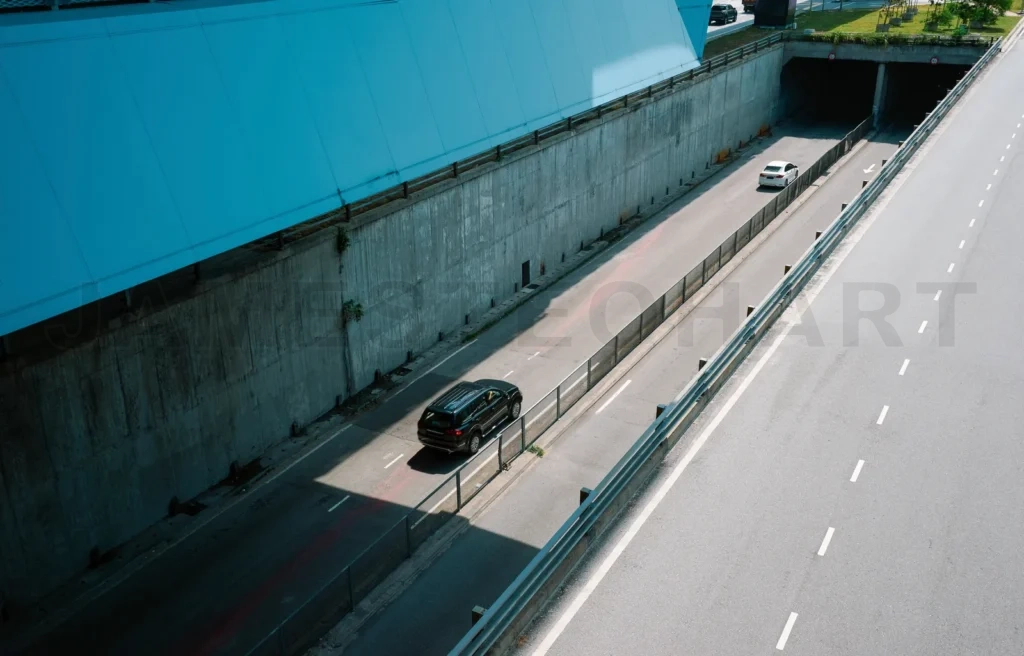 
Cars driving into tunnel on modern highway