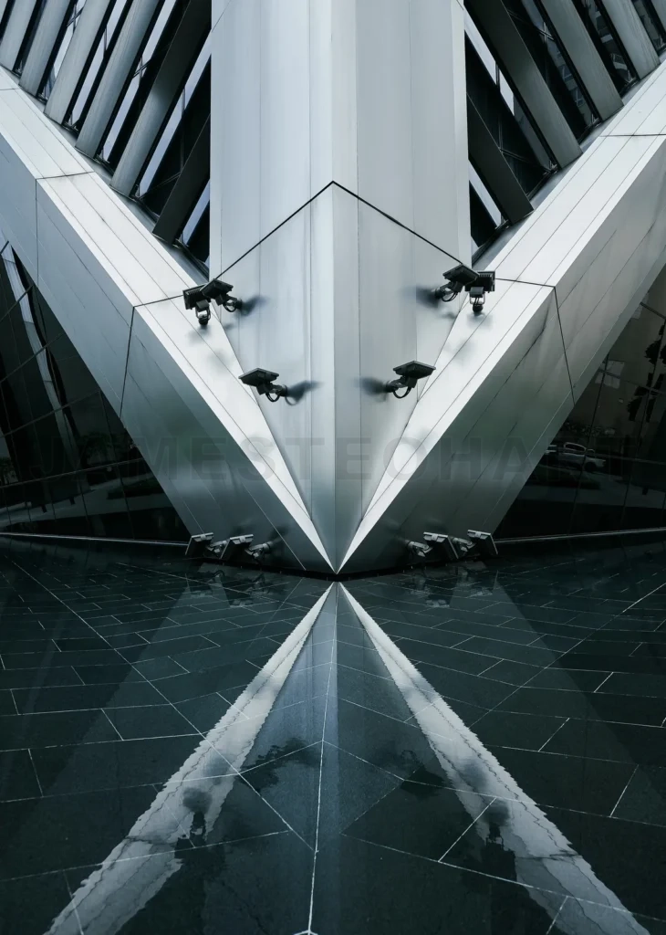 
Modern building facade with surveillance cameras and reflection