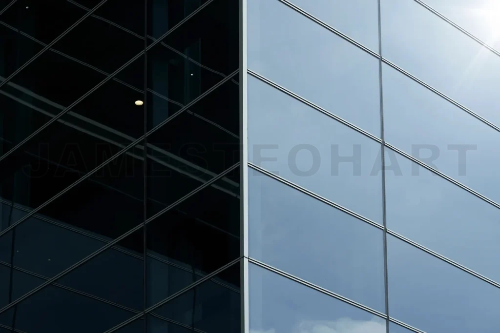 
Modern building reflecting sky with contrasting dark facade