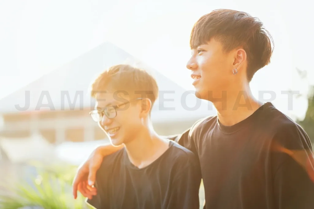 
Young asian men enjoying friendship outdoors with sunlight