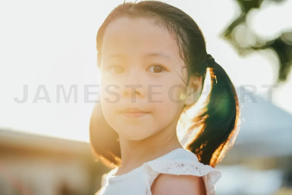 
Little girl looking forward with warm sunlight