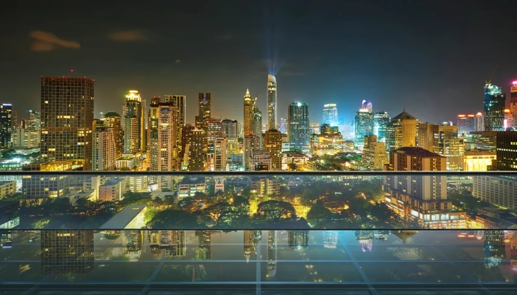 
Bangkok city night skyline reflecting on glass rooftop