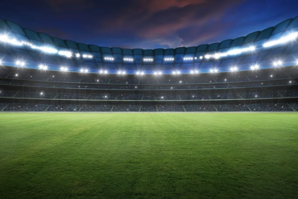 
Empty stadium field with bright pitch lights illuminating